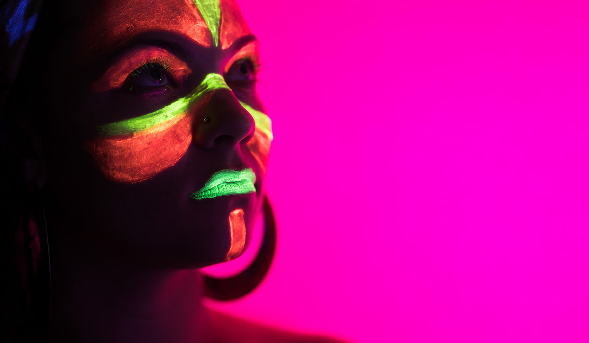 Portrait of woman in with neon makeup