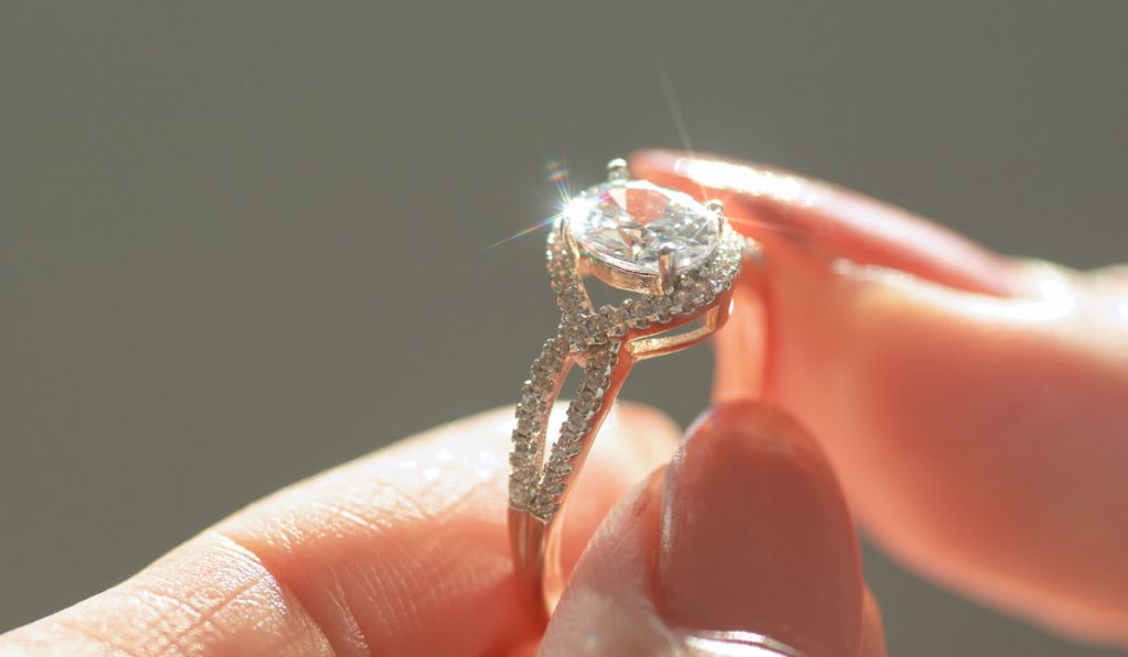 Close-up view of a diamond ring and woman hand
