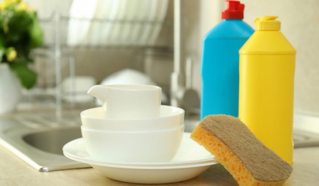 Concept of Dishwashing detergent accessories on kitchen background
