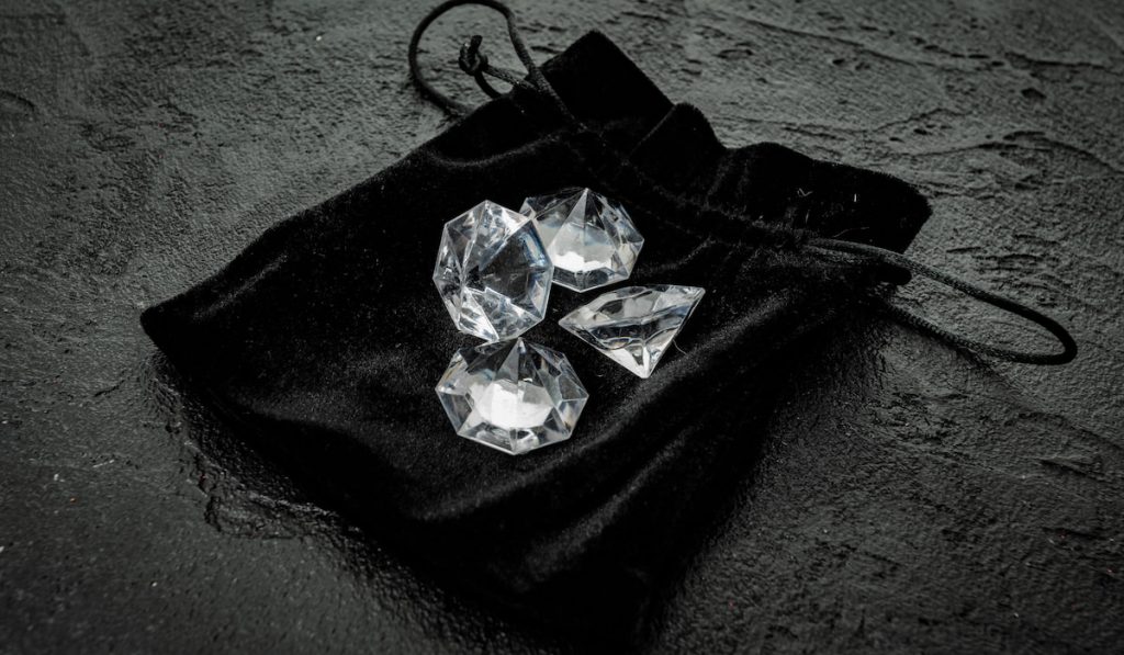 Diamond on black. Beautiful shining crystal
