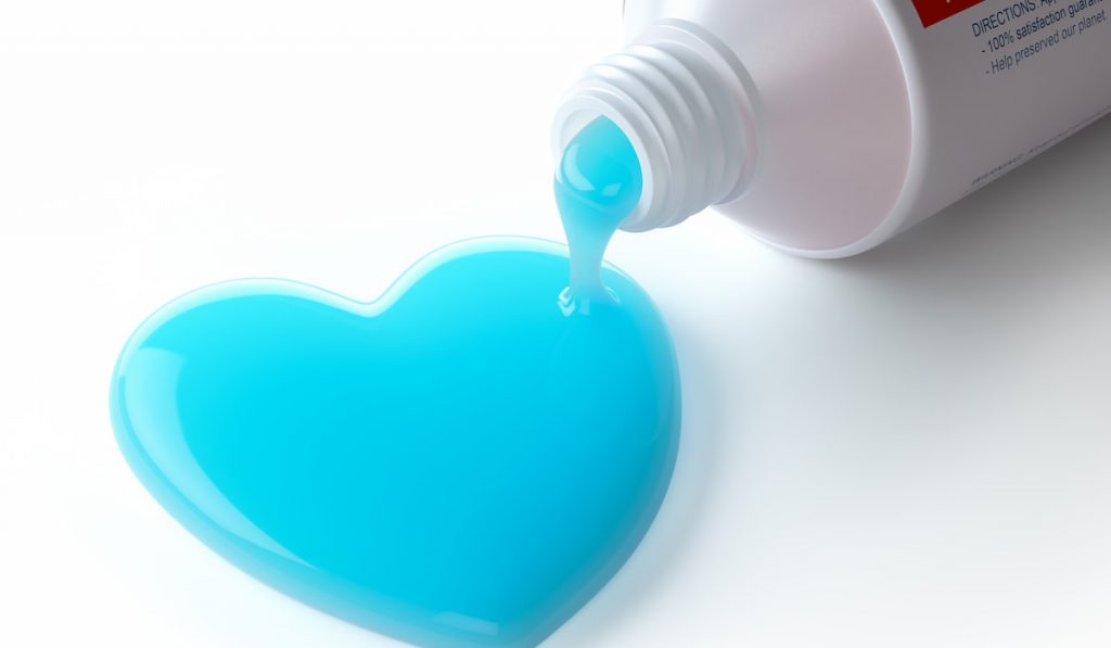 Toothpaste in the shape of heart coming out from toothpaste tube
